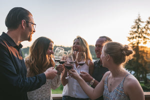 Wine Cheers with family at the winery at sunset 