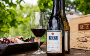 Bottles of Betz wine in front of a Betz wooden wine box